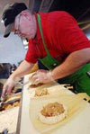 employee hand rolling Tucson Tamale tamales